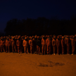 6 June 2017: Before dawn the Red Ants await their orders before departing on an operation in the city centre. Red Ants compound, South of Johannesburg.