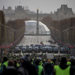 8 December 2018: Protesters walk towards a police line on the Champs-Elysées during the 'yellow vests' demonstration in Paris, France. (Photograph by Chris McGrath/Getty Images)