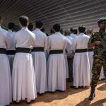 23 April 2019: A soldier stands guard behind Catholic priests and other clergy members during a mass funeral at St Sebastian's Church in Negombo. Sri Lankan authorities declared a state of emergency on Monday. (Photograph by Carl Court/Getty Images)