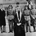 22 January 1919: Emir Feisal at the Palace of Versailles during the Paris Peace Conference. Behind him, left to right, are Rustin Day, Nuri Es-Sa’id, Pisani, Lawrence, Haidar of Baalbek and Hassan Dey Qadri. (Photograph by Hulton Archive/Getty Images)