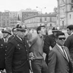 28 August 1968: A police officer escorts a demonstrator from Mexico City’s Central Plaza during an anti-government rally. Riot police and soldiers opened fire to break up the protest. (Photograph by Bettmann/Contributor)