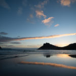 As the sun sets behind Sentinel Peak, part of the Table Mountain range, it casts a shadow over the Hangberg ghetto.