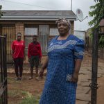 29 November 2018: (Right to left) Mary Mwale with her grandson Lesedi Chombo and daughter Patience Chombo outside their home in Katlehong.