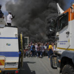 3 April 2019: A heavy police contingent looks on as Alexandra residents shut the township down in protest.