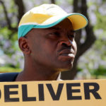 A man displays a placard while participating in a Cosatu march in Johannesburg against the implementation of e-tolls, a better public transport system as well as the banning of labour brokers and the scrapping of the youth wage subsidy, Thursday, 14 November 2013. Picture: Werner Beukes/SAPA