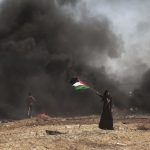 14 May 2018: A woman waves a Palestine flag in Gaza City. Israeli soldiers killed at least 41 Palestinians and wounded more than 1 000 as demonstrations coincided with the US embassy opening in Jerusalem. (Photograph by Etienne De Malglaive/Getty Images)