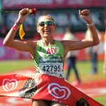 29 May 2016: Charne Bosman, of Murray and Roberts, in the colours of her former team Nedbank Running Club, celebrates winning the Comrades Marathon in Durban. (Photograph by Ian Carbutt)