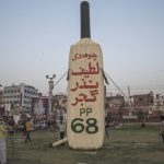 5 May 2013: Pakistan Tehreek-e-Insaf supporters hoist an inflatable cricket bat, the election symbol of party chair Imran Khan, who went on to become prime minister. (Photograph by Daniel Berehulak/Getty Images)