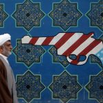 22 February 2007: An Iranian cleric walks past a mural on the wall of the former US Embassy in Tehran. Earlier that week media reports said that the US had plans for bombing Iran, a scenario that is again possible today. (Photograph by Majid Saeedi/Getty Images)