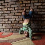 13 March 2019: Four-year-old Zbusiso Ntshangase does a handstand between activities at the early childhood development centre in Germiston run by Noetsie Elizabeth Brink.