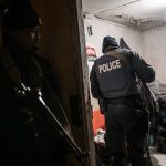 12 July 2019: South African Police Service officers conduct searches in homes across Phlippi East in the early hours of the morning.