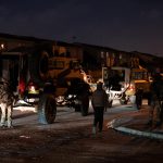 18 July 2019: A convoy of SANDF vehicles moves through Manenberg, with army soldiers keeping watch on a street corner.