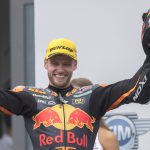 11 August 2019: South African Brad Binder, riding for the Red Bull KTM Ajo team, celebrates his Moto2 victory on the podium in Spielberg, Austria. He will be riding in the MotoGP class in 2020. (Photograph by Mirco Lazzari gp/Getty Images)