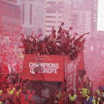 2 June 2019: Liverpool's squad atop a parade bus during their victory procession through the city of Liverpool with the UEFA Champions League trophy that they won by beating Tottenham Hotspur. (Photograph by Nigel Roddis/Getty Images)