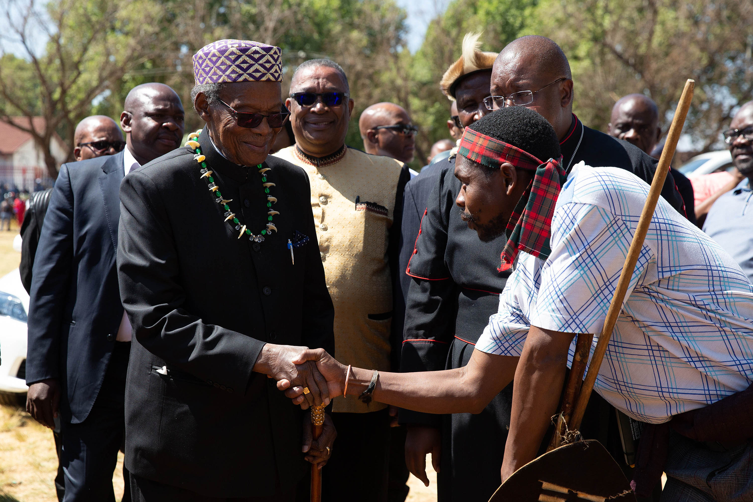 8 September 2019: Mangosuthu Buthelezi greeting a Joburg hostel dweller as he arrived at the gathering of men to discuss the violence taking place in the city. (Photograph by James Oatway)