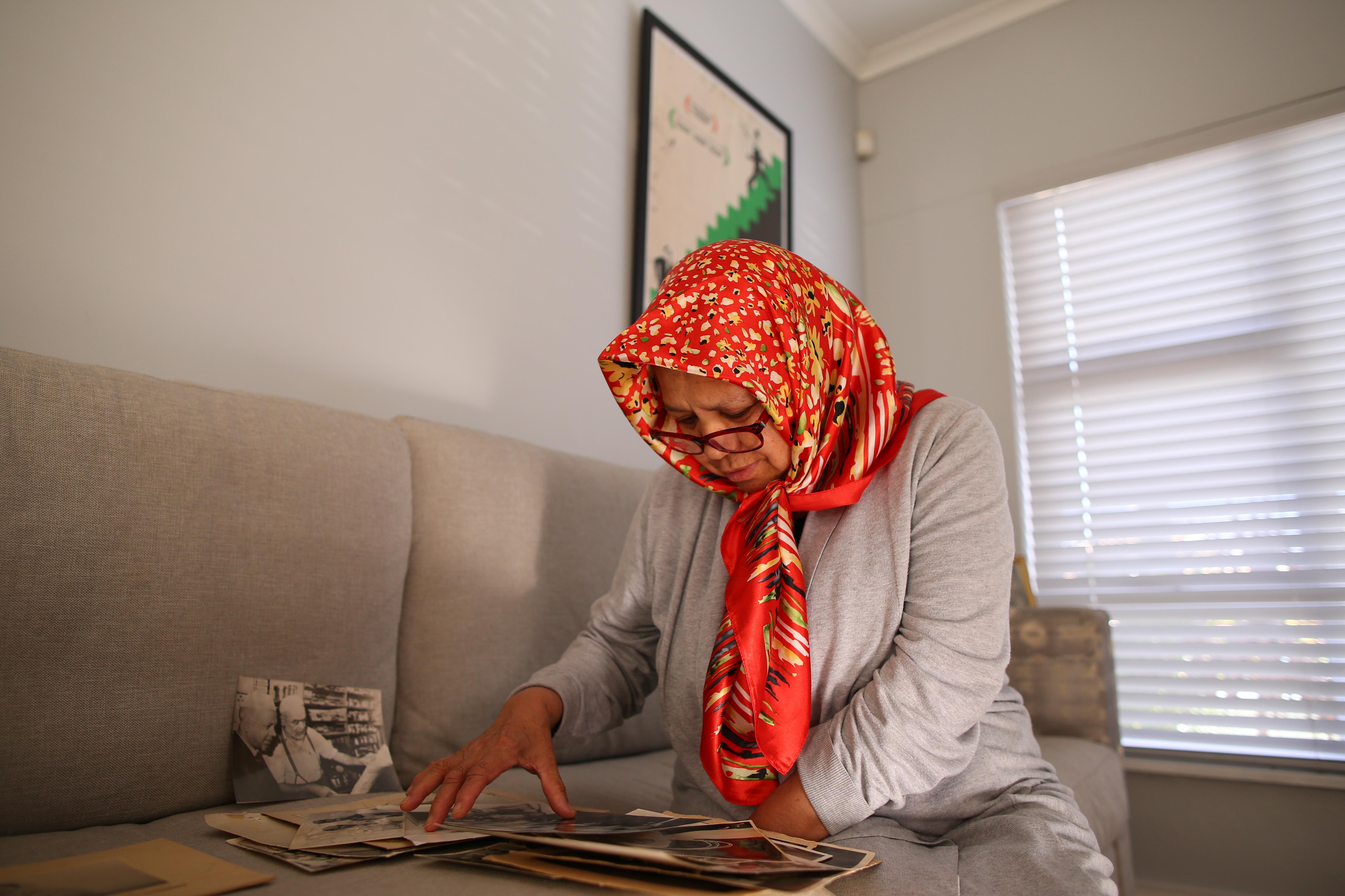 12 September 2019: Shamila Haron, Imam Haron’s daughter, looks at old family photographs at the family home in Athlone, Cape Town.