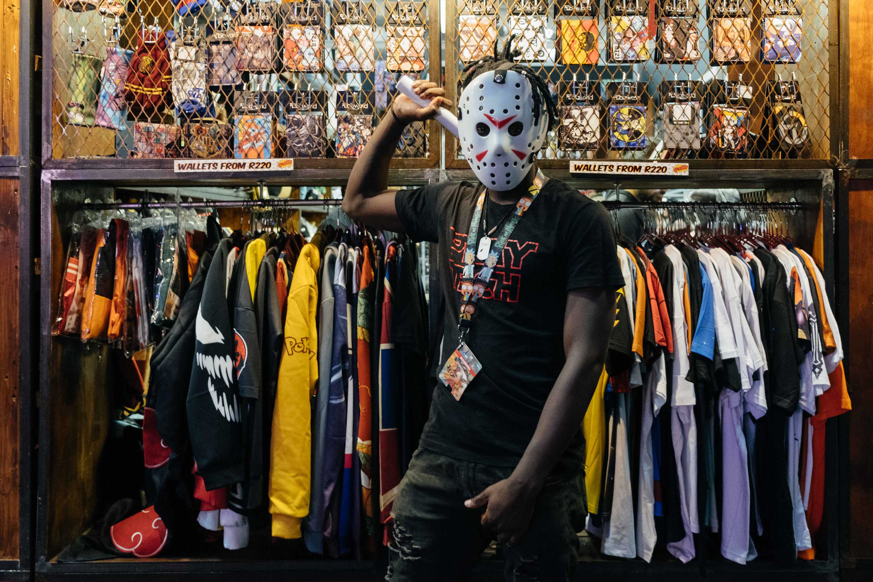 24 September 2019: Denzel Reaper wearing a mask inspired by Jason from the Friday the 13th movie franchise, in front of the stall he was manning at Comic Con Africa. (Photograph by James Puttick)