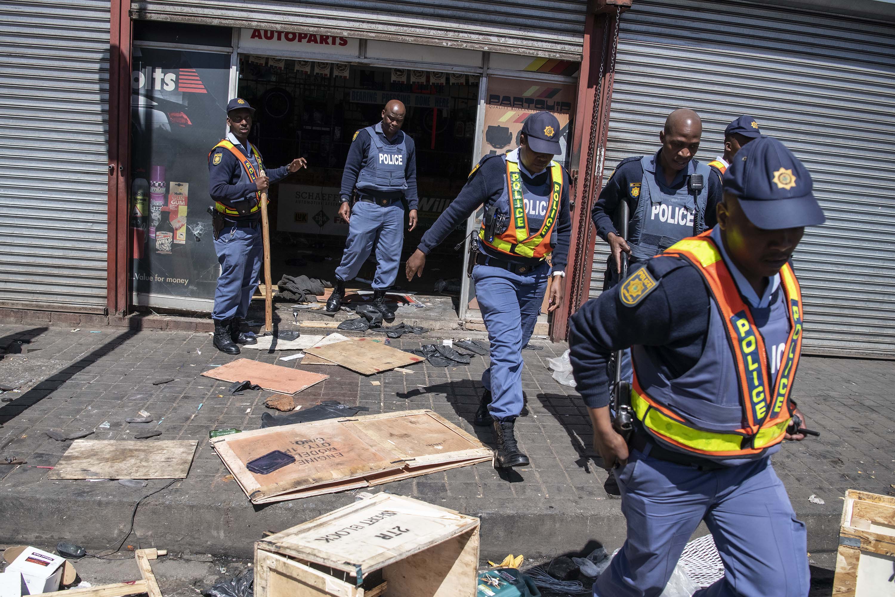 2 September 2019: Members of the South African police exit a shop that had just been looted by xenophobic rioters in the Johannesburg CBD.