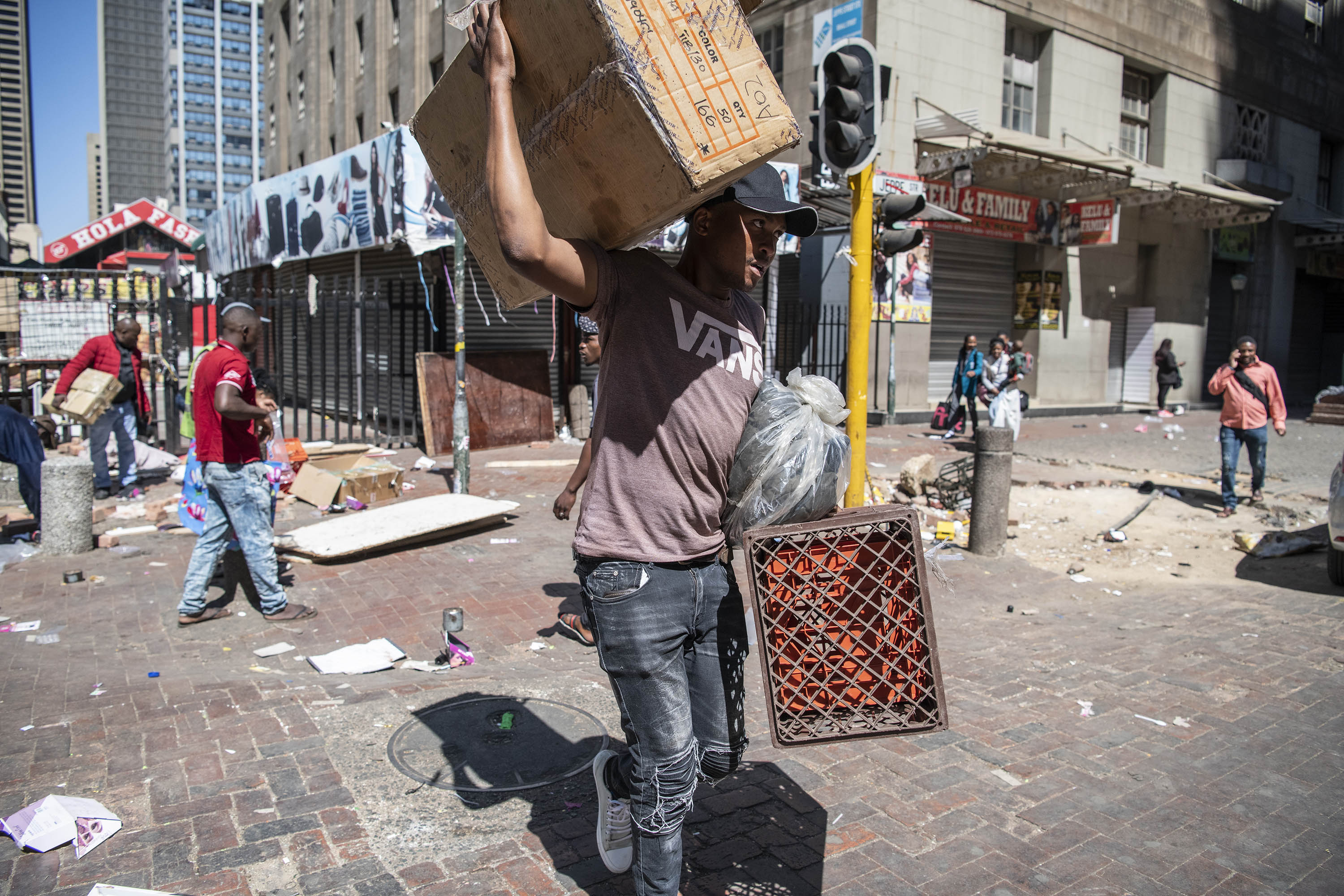 2 September 2019: A street trader trying to salvage what is left of his stock. 