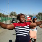 25 June 2019: Two of a group of women protesting outside the LanXess-run Rustenburg Chrome Mine, demanding that managers hear their grievances about sexual harassment in the workplace. (Photograph by Sandile Ndlovu)