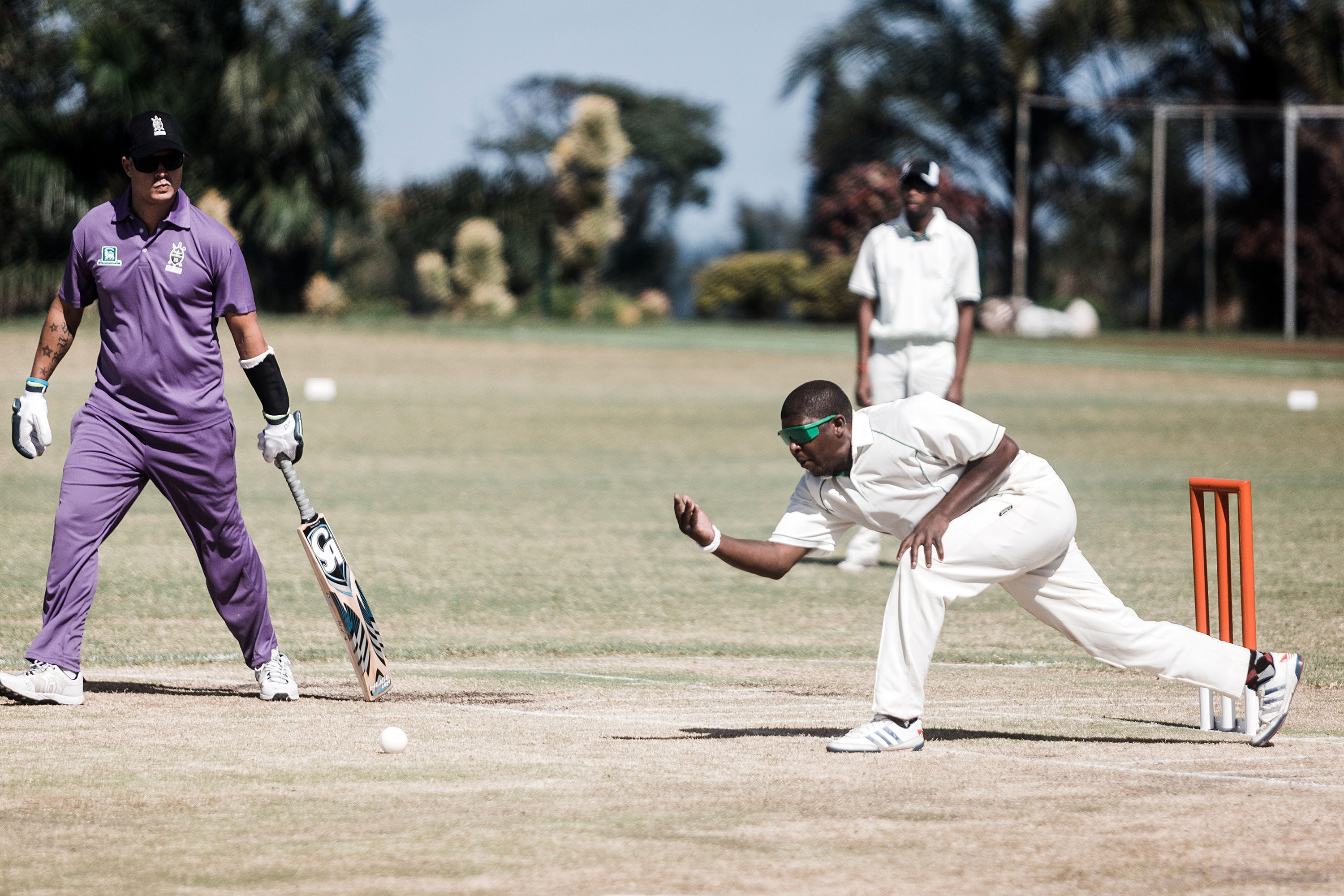 25 September 2019: A player from the Free State, in white, bowls against Kwazulu-Natal in purple. Blind and partially sighted cricketers rely on commentary from fellow players to gauge the path of the ball. 
