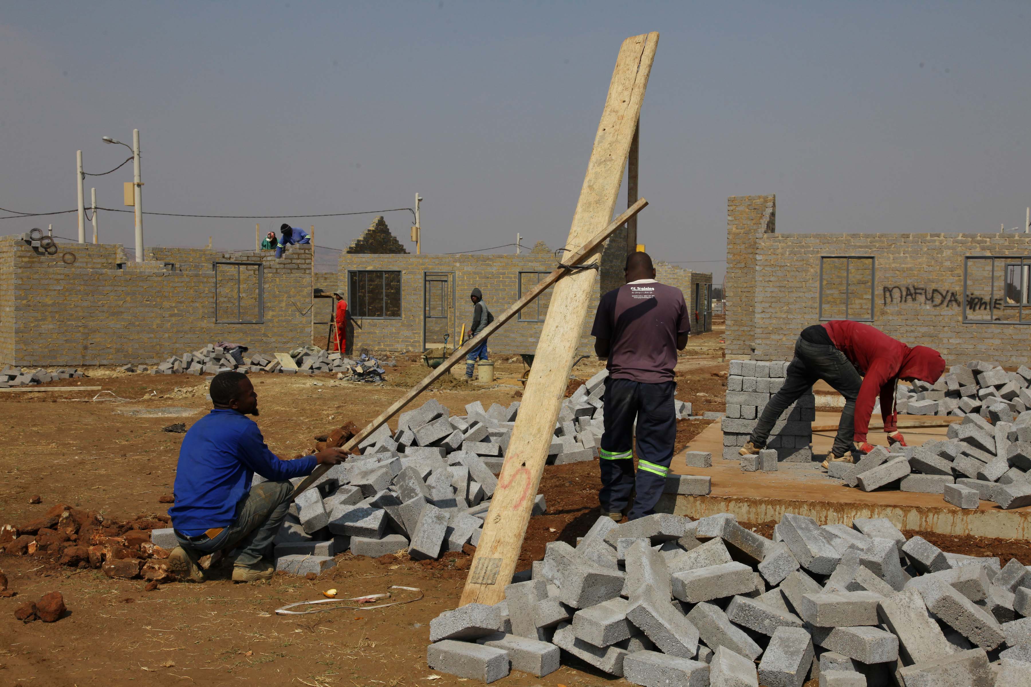 08 August 2019: Workers prepare bricks on a construction site reserved to build RDP houses for MK veterans at Palm Ridge.