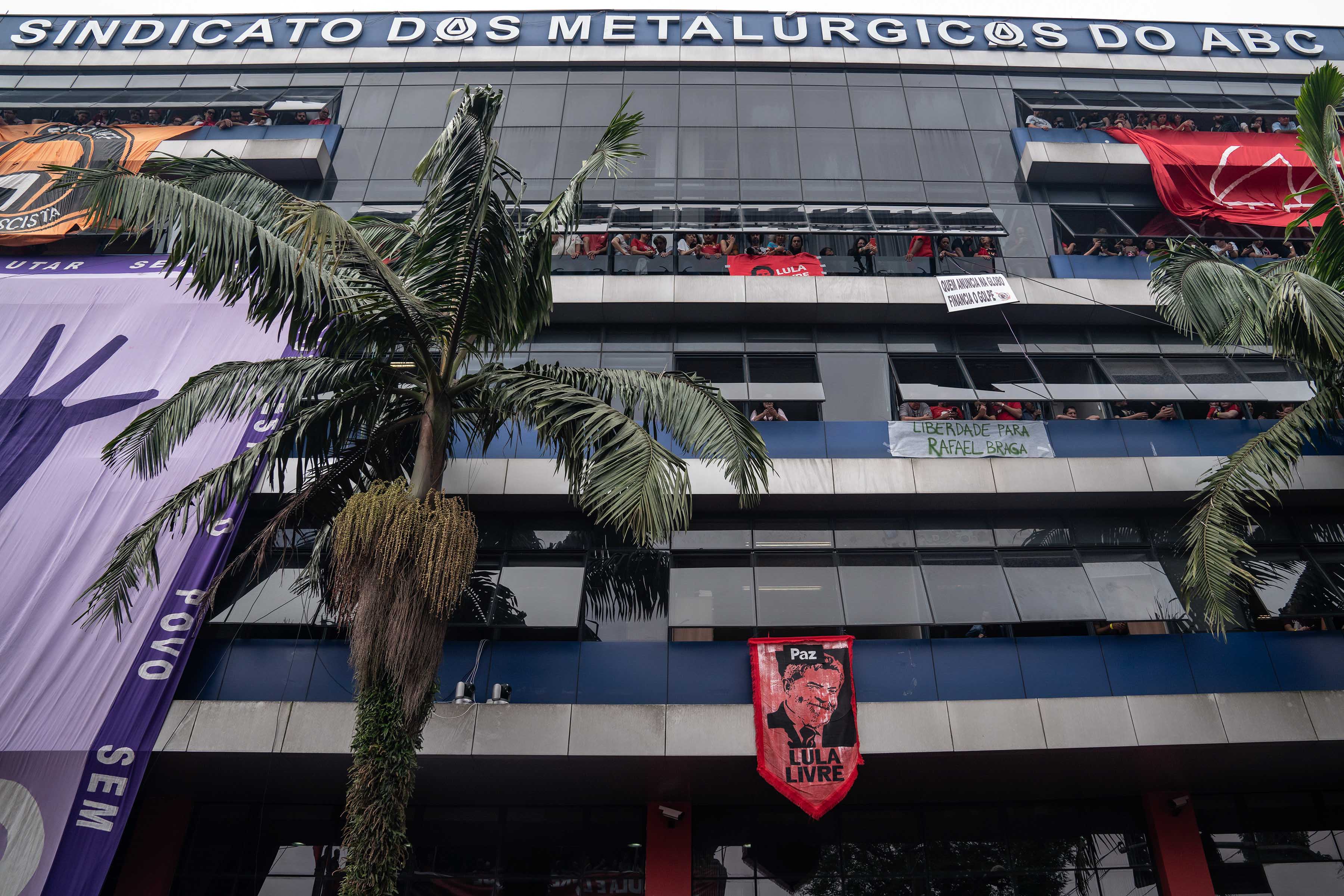 9 November 2019: People peer down from the windows of the ABC Metalworkers Union headquarters in the south of São Paulo, where a massive rally celebrated Lula’s release. 