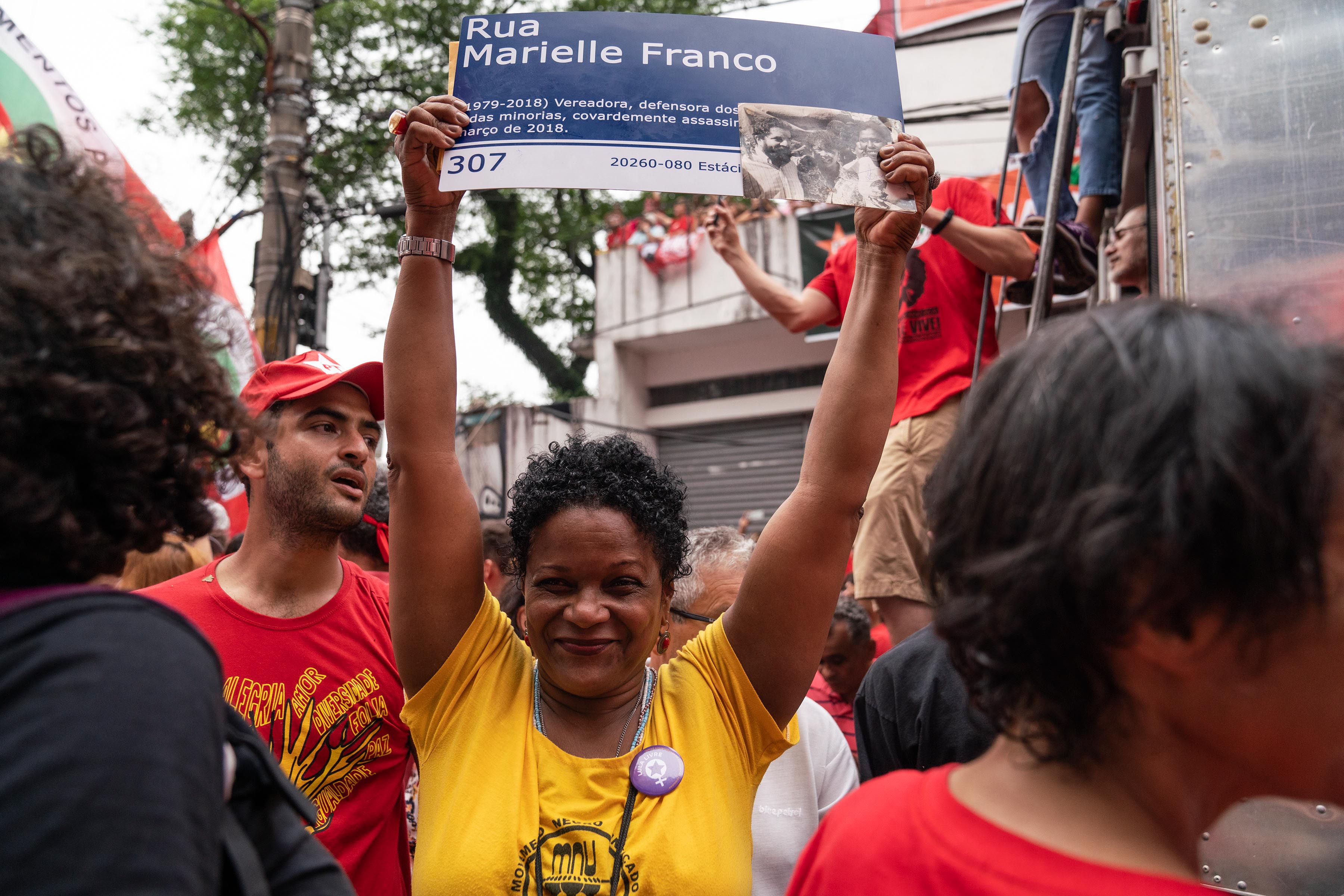 9 November 2019: A woman holds up a poster with the name of the human rights defender, Marielle Franco, who was murdered in Rio de Janeiro last year.