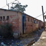 17 October 2019: One of the communal toilets shared by residents in KwaMashu Hostel. The toilets are unisex and are used by adults and children. Blocked pipes and drains have been ignored for years. A pool of raw sewage stagnates next to the toilets. (Photographs by Nomfundo Xolo)