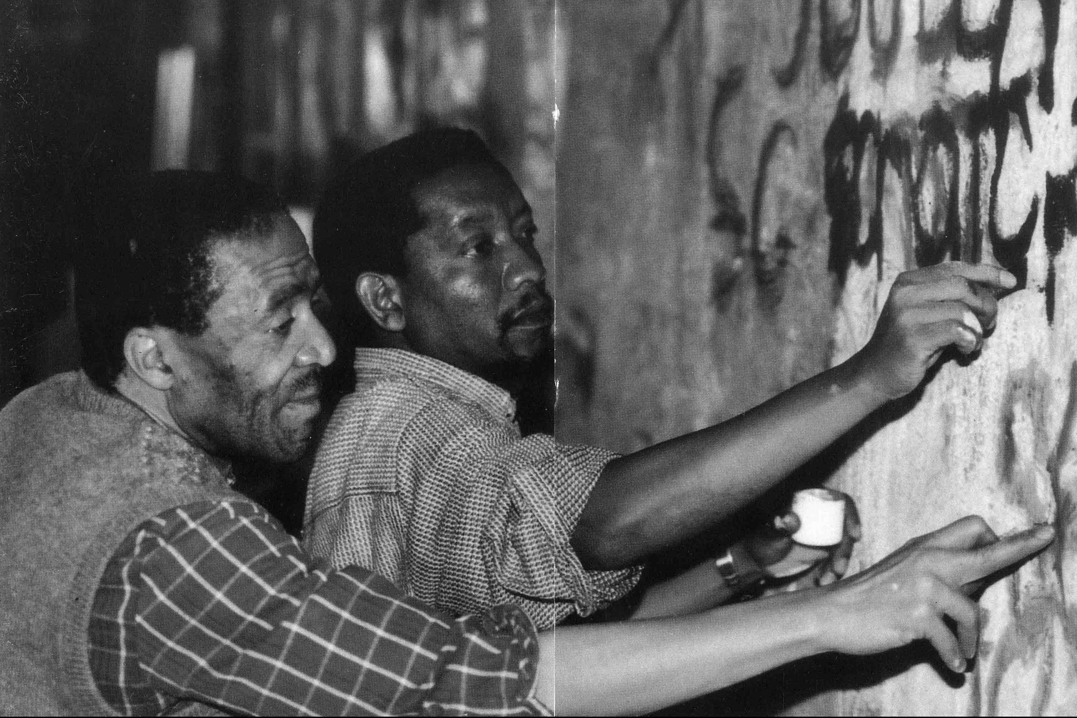 1997: Koloane with friend and fellow artist Pat Mautloa at the National Festival of the Arts, working on the mural If You Scratch at the Monument Theatre. (Photograph: Supplied)