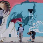 26 July 2016: From left, Rasty, Falko and Myza working on a collaborative mural in Jeppestown, Johannesburg. (Photograph by Tseliso Monaheng)