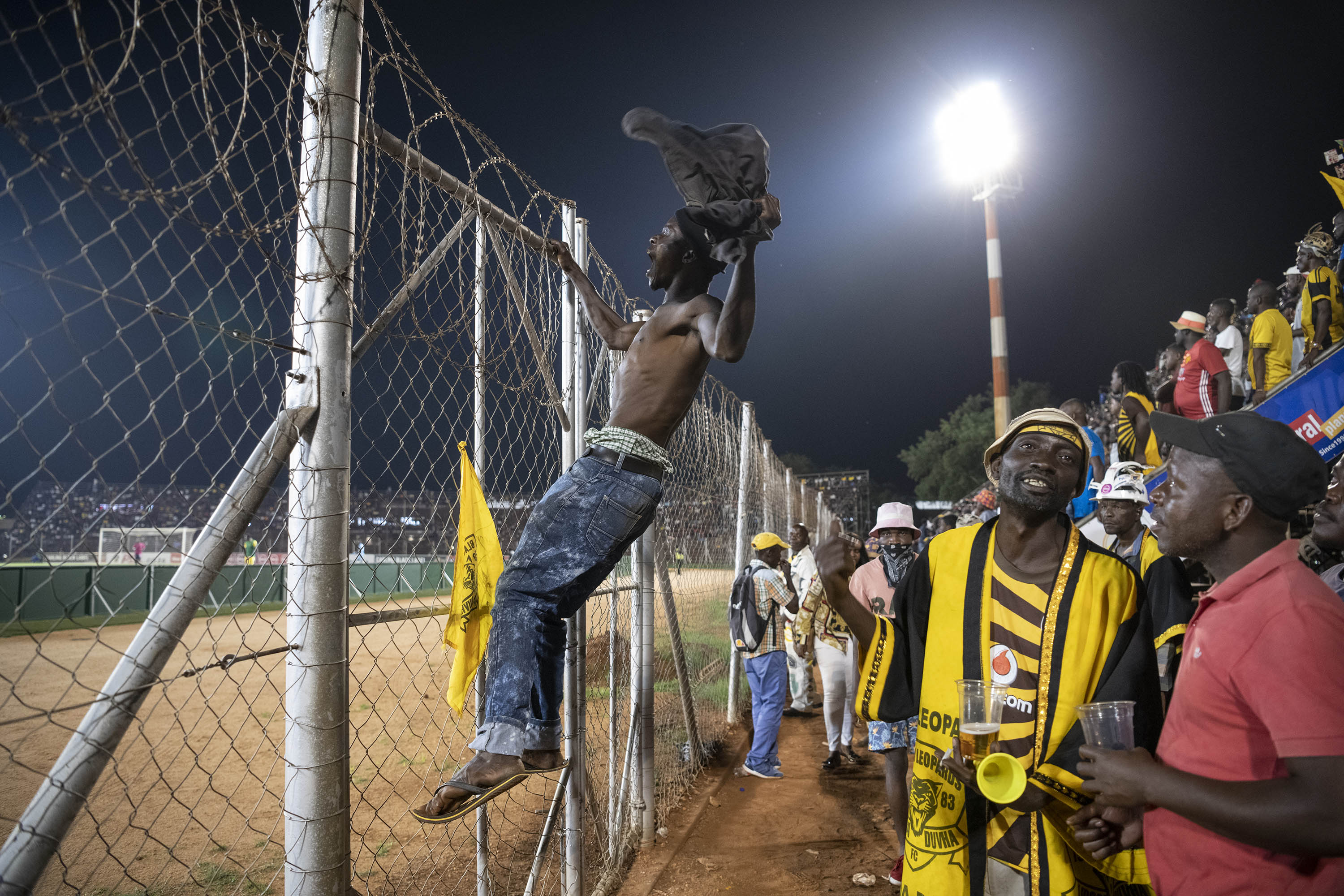 30 November 2019: A Black Leopards fan climbs the security fence in front of the Zamalek stand to berate the referee. 