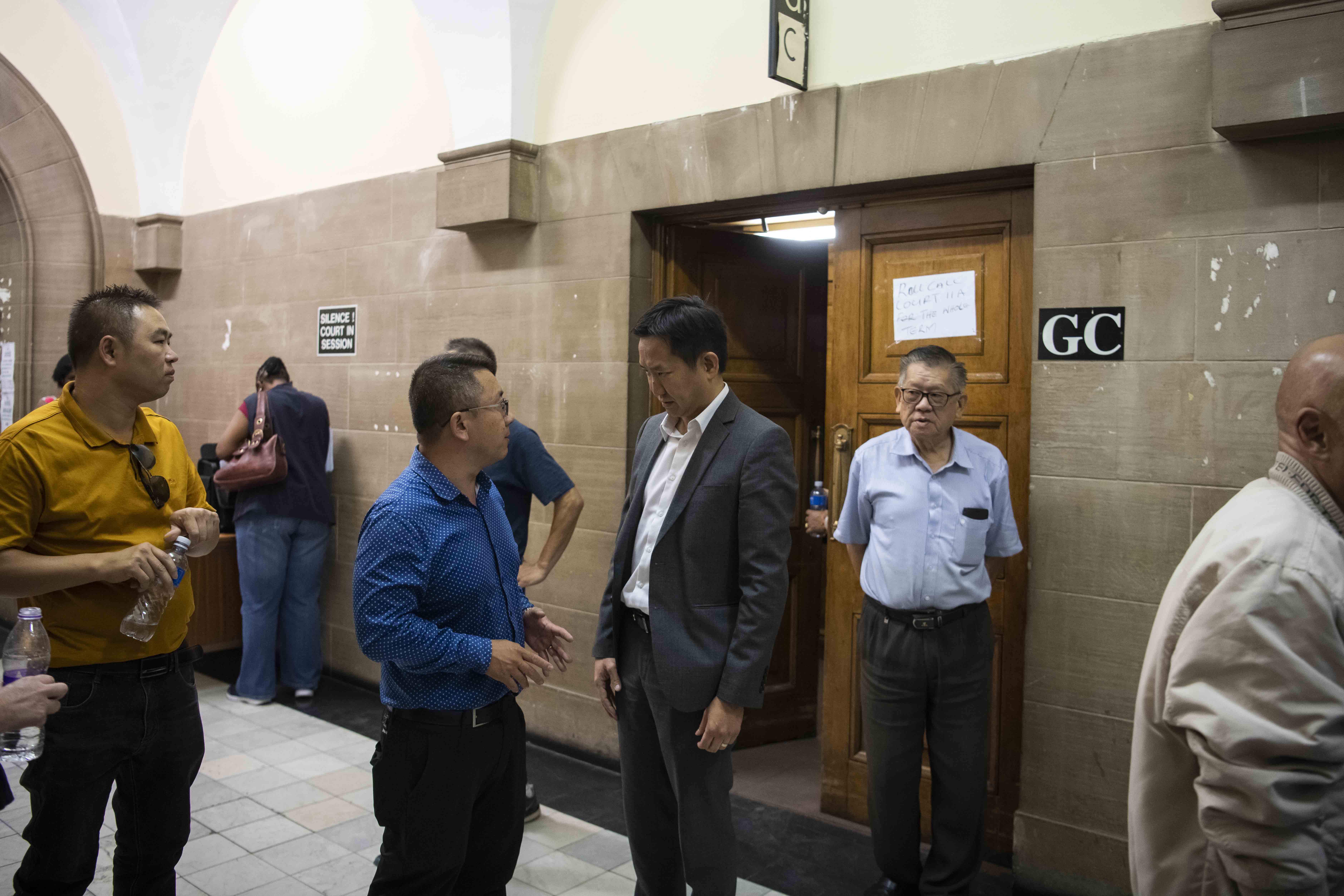 5 November 2019: Second from right, TCA chair Erwin Pon chatting to other members of the South African Chinese community outside the courtroom at the Johannesburg High Court. 