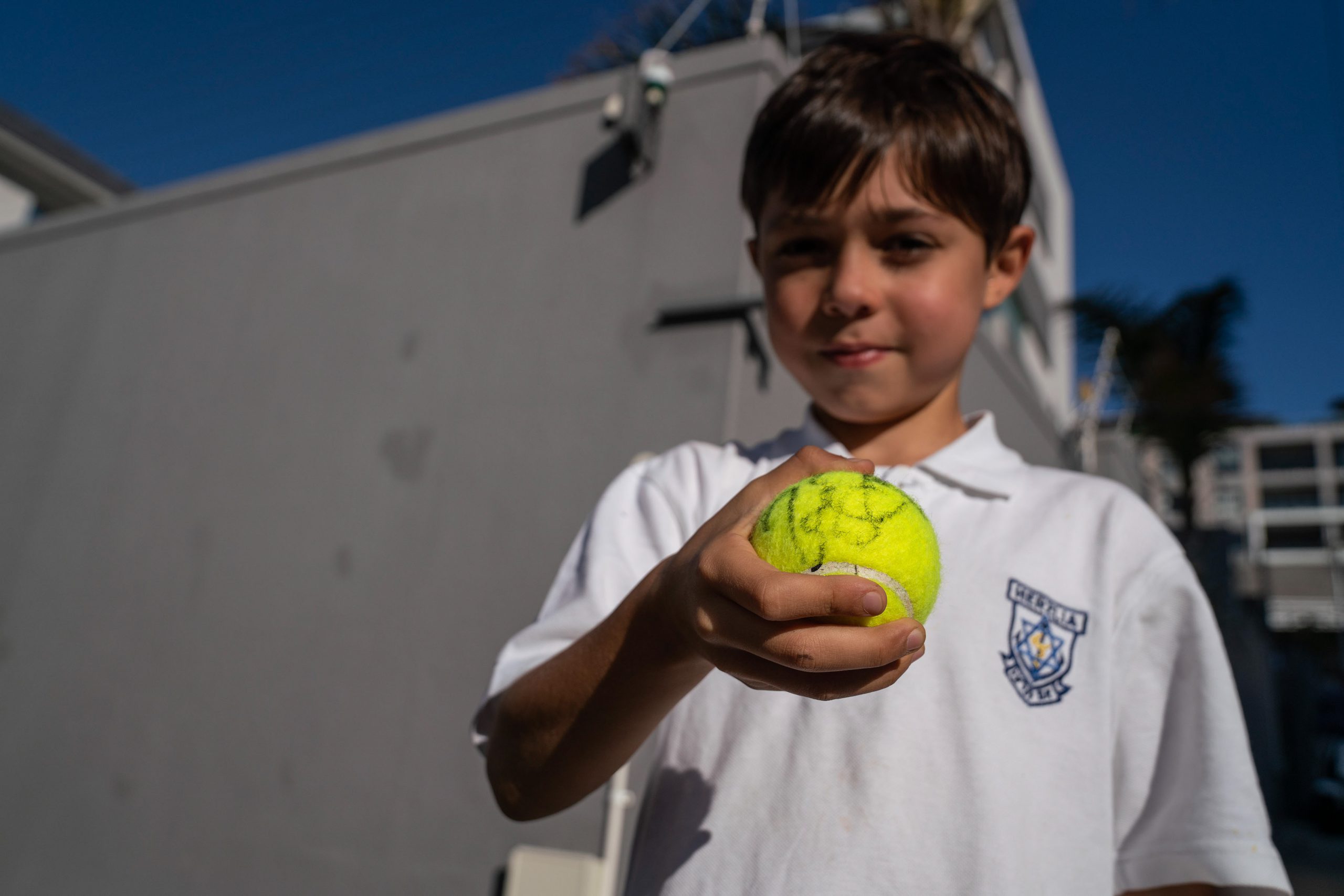 6 February 2020: Tennis fan Jonah Khan shows off a ball signed by Roger Federer after the legend visited the Anthony Harris Tennis Academy in Sea Point. 