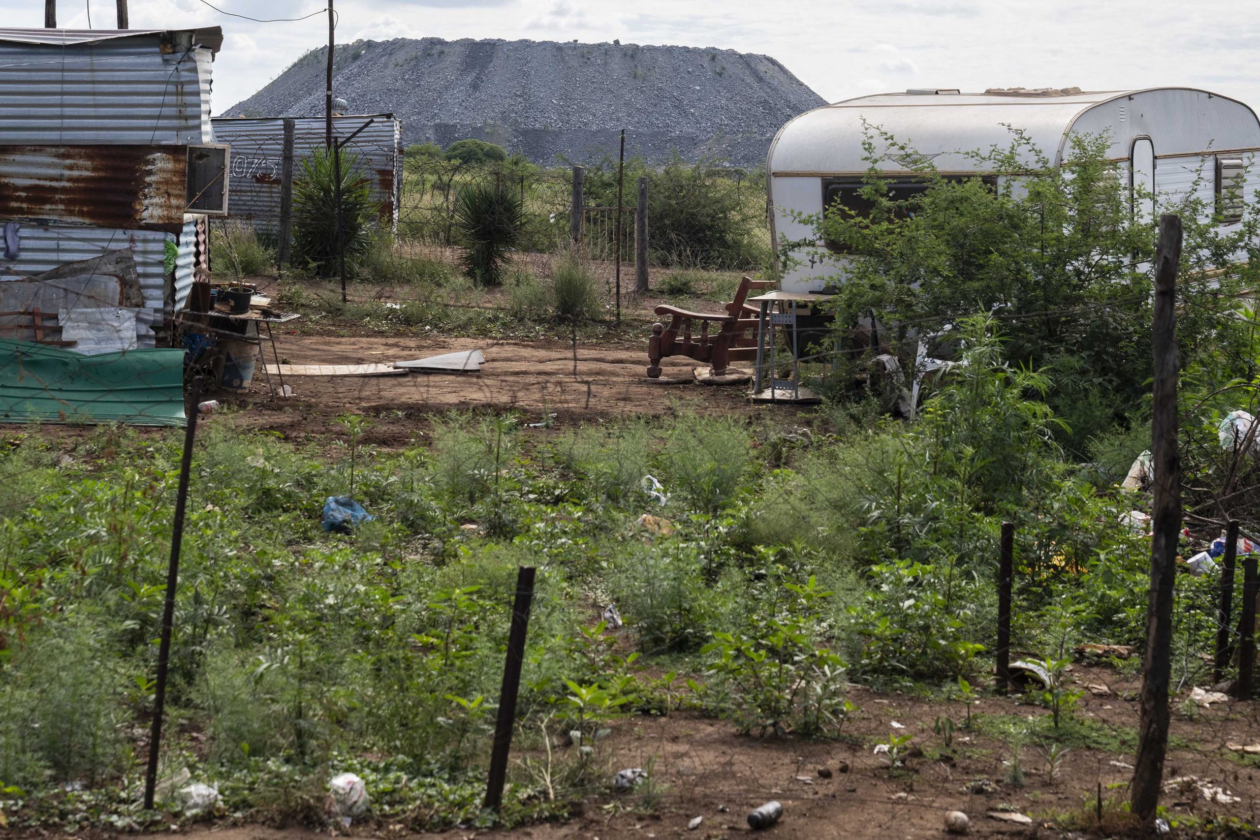 12 February 2020: A mine dump looms over the shack settlement of Bokamoso, outside Mooinooi in the North West province. The majority of the residents of the settlement work in the nearby chrome and platinum mines. 