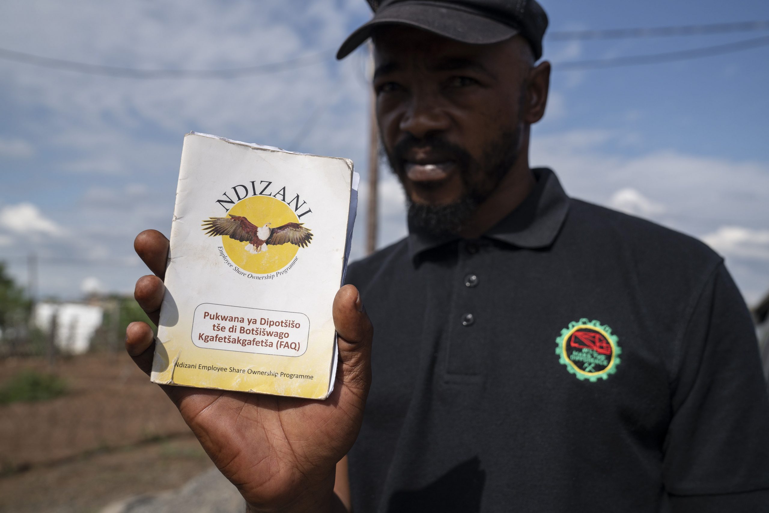 12 February 2020: Edward Koli, who works at the Samancor chrome mine, holds up the pamphlet detailing the Ndizani Employee Share Ownership Programme. 