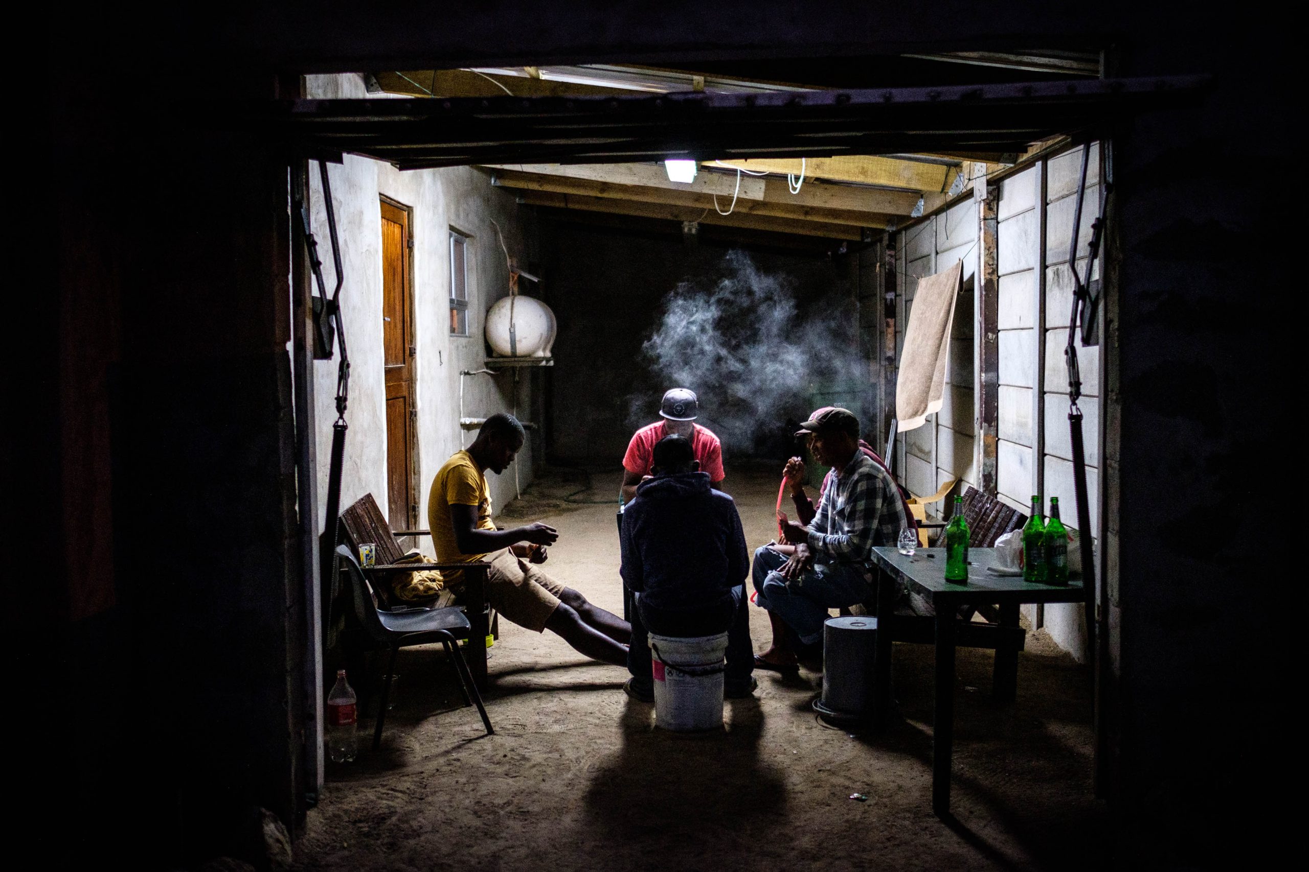 06 December 2019: A group of fishermen play cards after a long day at sea.