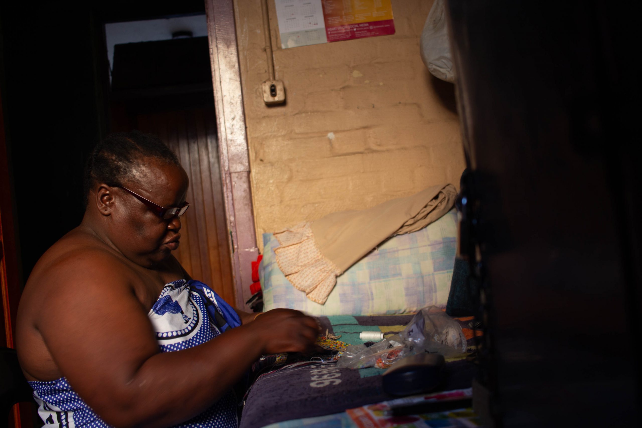 13 February 2020: Busi Msomi is a beader. She works in her room, using coloured beads to create her designs by the light from her window. 