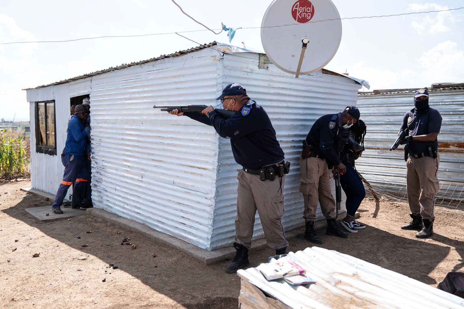 21 April 2020: The metro police fire rubber bullets at residents resisting eviction in Lakeview. Several of them were cornered in this house and arrested. (Photograph by James Oatway)