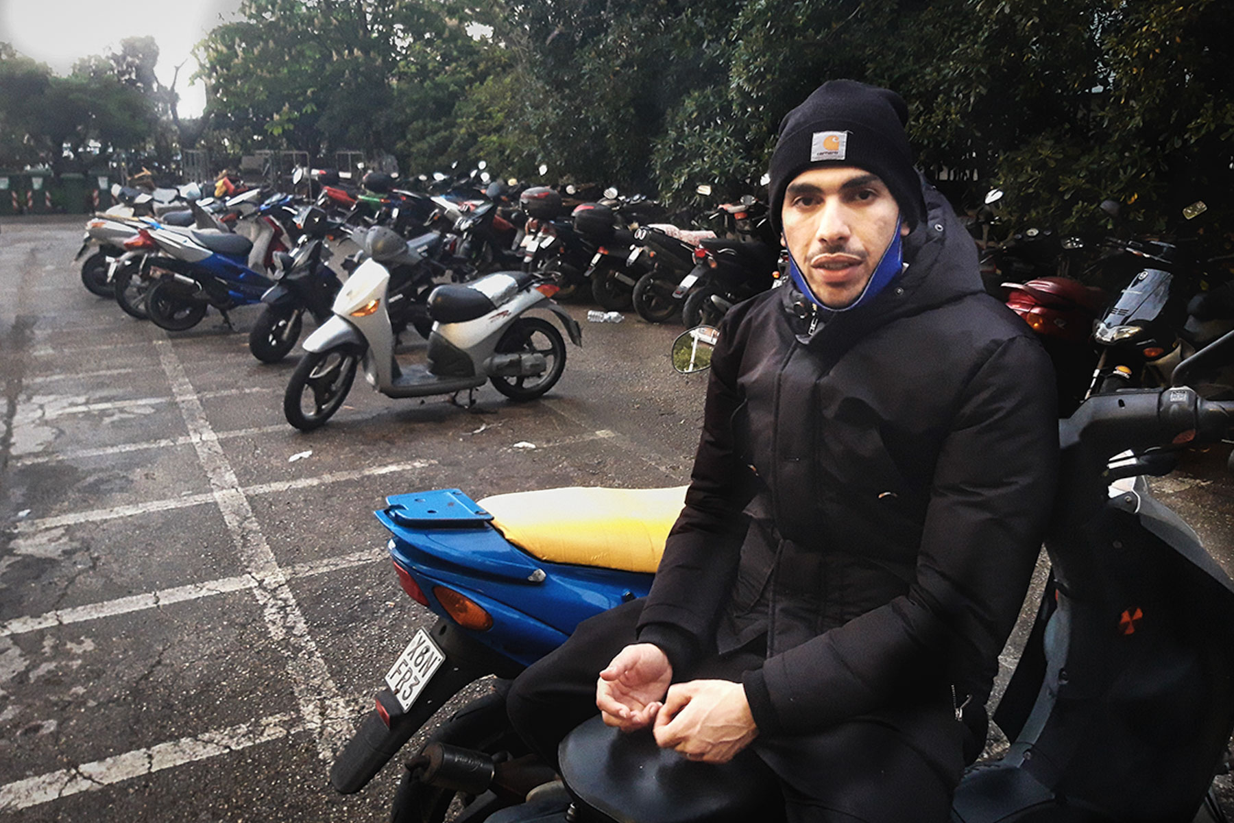 22 April 2020: Mouad in the parking lot outside his home after going to the supermarket. His employer has told him there is a chance he will start working again when the lockdown in Italy eases on 4 May. (Photograph by Alex Čizmić)