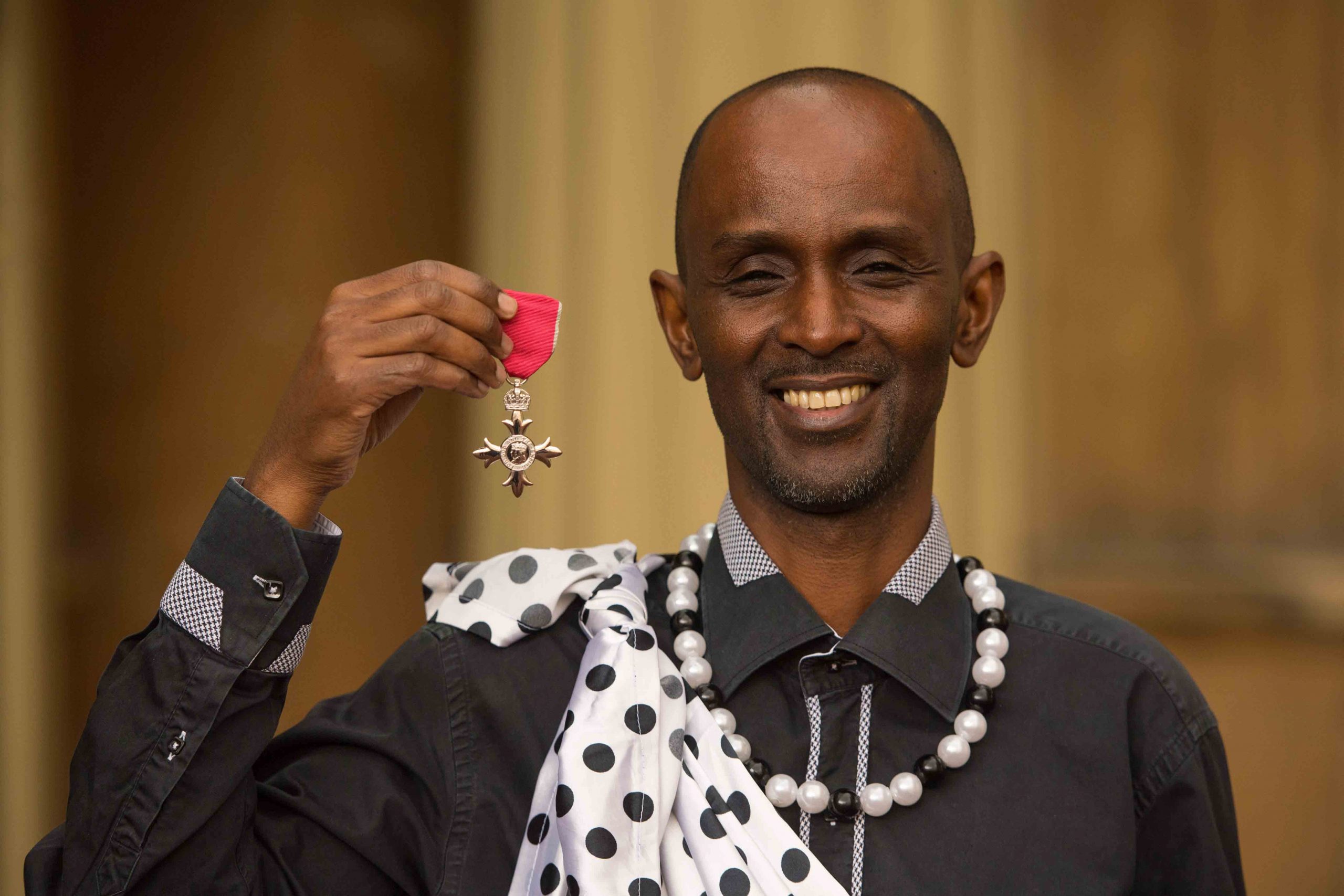 15 March 2018: Eric Eugène Murangwa with the MBE medal he received from the Prince of Wales after an investiture ceremony at Buckingham Palace in London, England. (Photograph by Dominic Lipinski-WPA Pool/ Getty Images)