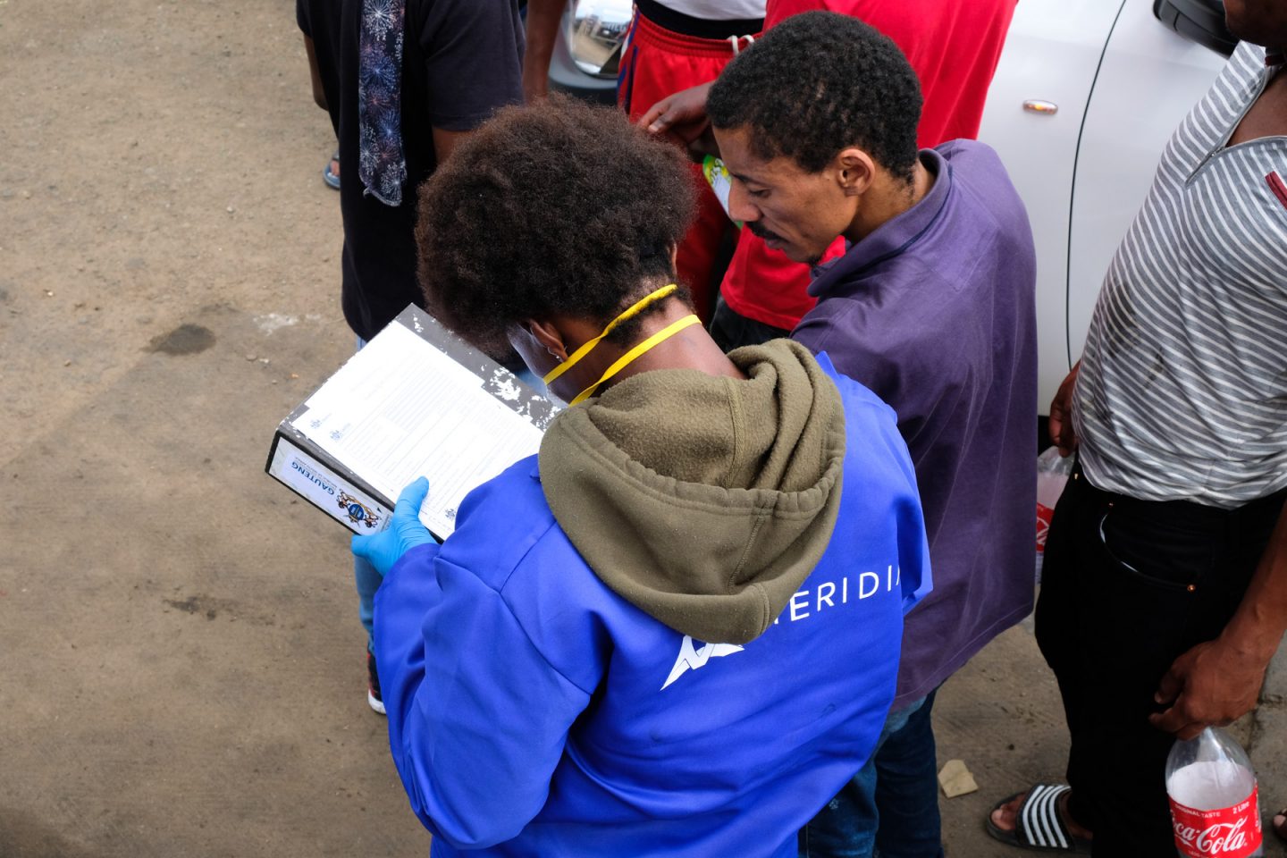 1 April 2020: A Meridian worker records the details of one of the many Alex residents provided with sanitiser. 