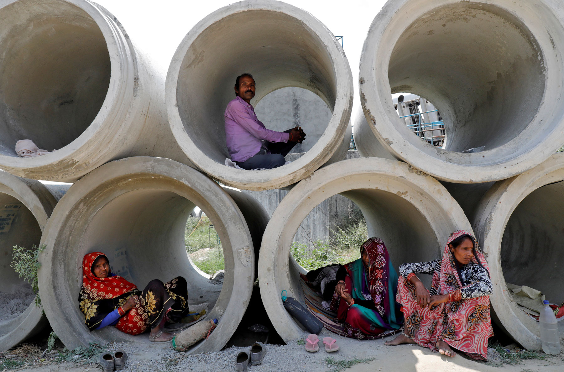 22 April 2020: Migrant labourers rest in cement pipes in Lucknow, India, during the country’s nationwide lockdown. Many of them were stuck without food or shelter after it was imposed. (Photograph by Reuters/ Pawan Kumar)