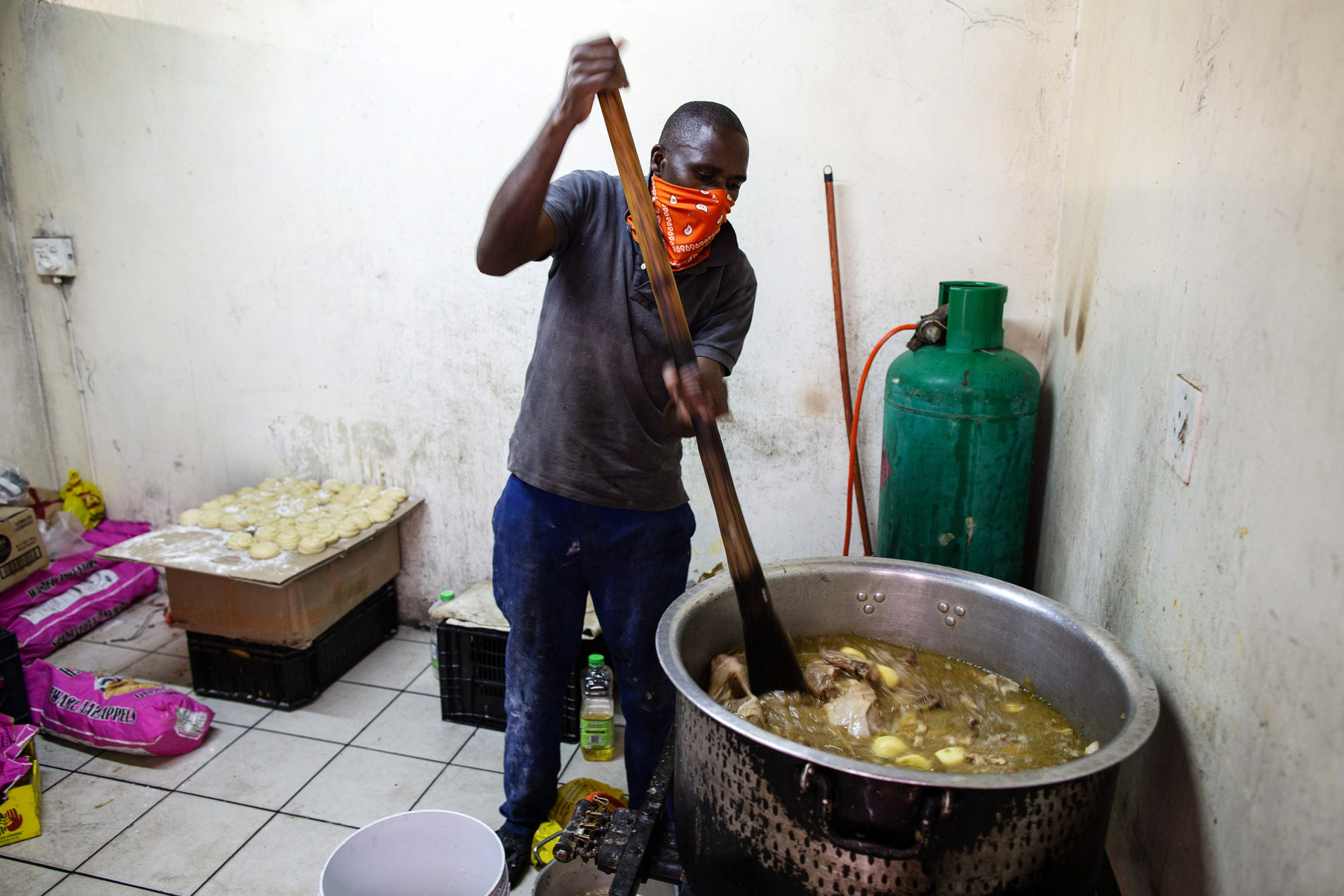 12 May 2020. Yusuf Bwanali from Malawi cooking the food. The African Diaspora Forum prepared and distributed hot meals for vulnerable migrants in Johannesburg. Photograph by James Oatway.