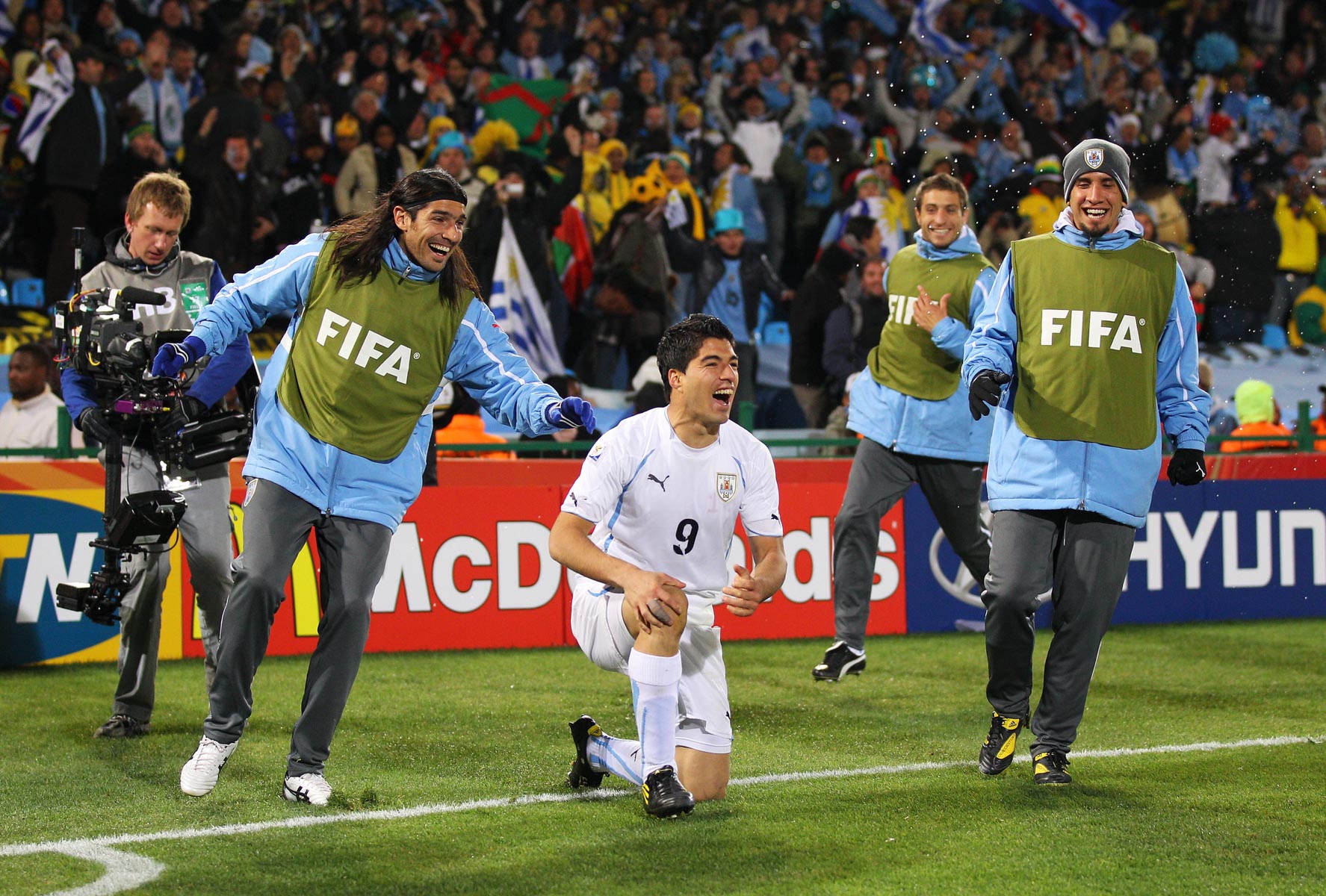 16 June 2010: Luis Suarez celebrates Uruguay’s victory with his teammates at Loftus Versfeld. (Photograph by Cameron Spencer/ Getty Images)