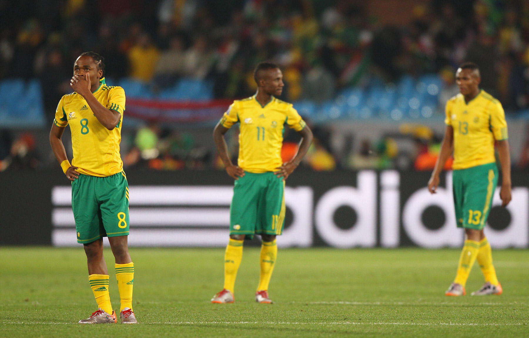 16 June 2010: South Africa’s Siphiwe Tshabalala, Teko Modise and Kagisho Dikgacoi look dejected after Bafana’s defeat to Uruguay. (Photograph by Michael Steele/ Getty Images)