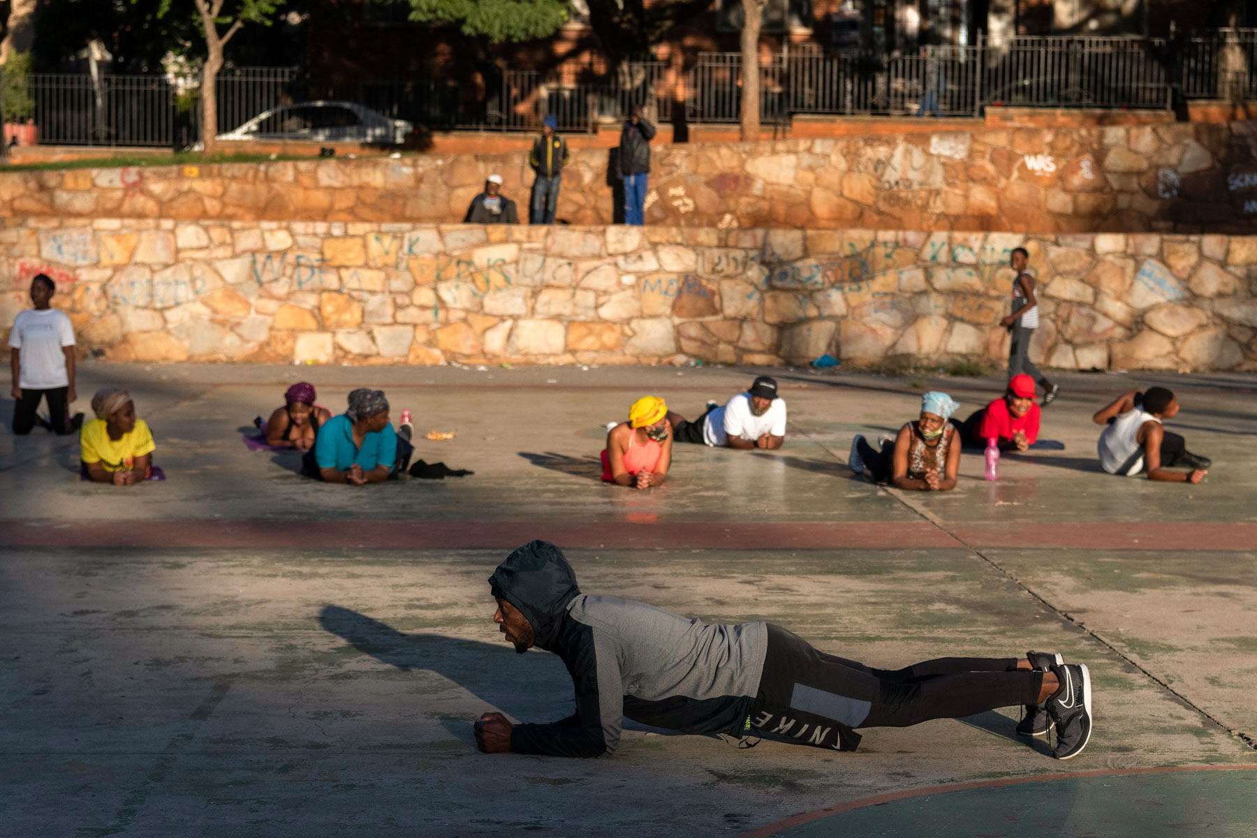 12 May 2020: Thulani Khupe leads people in an early morning exercise routine in Berea, Johannesburg. 