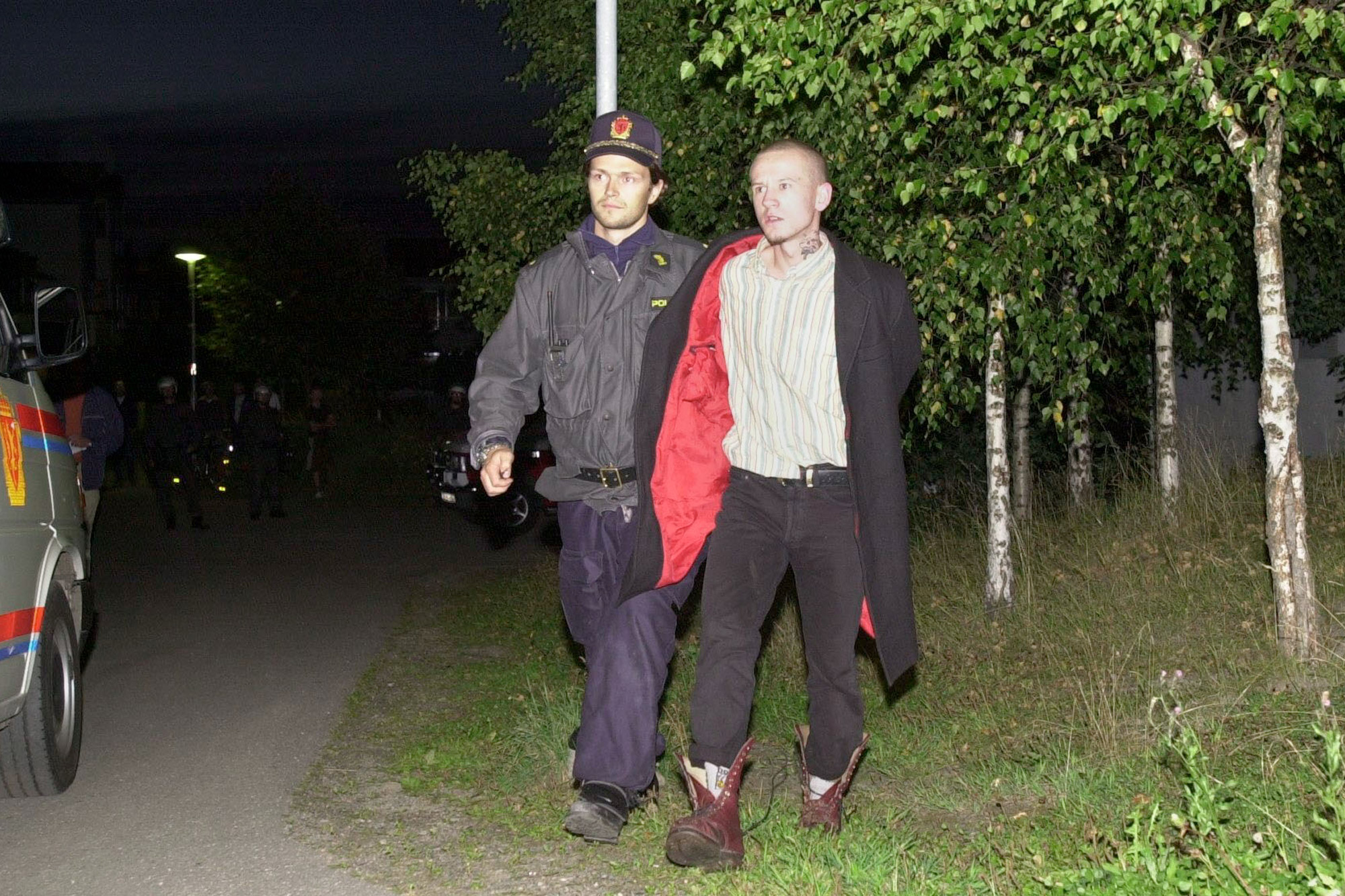 1 May 1996: From left, a police officer detains Petter Gundersen, one of the five neo-Nazis who were charged with the murder of 15-year-old Benjamin Hermansen in January 2001. (Photograph by Alexander Nordahl/ All Over Press Norway/ Liaison) 