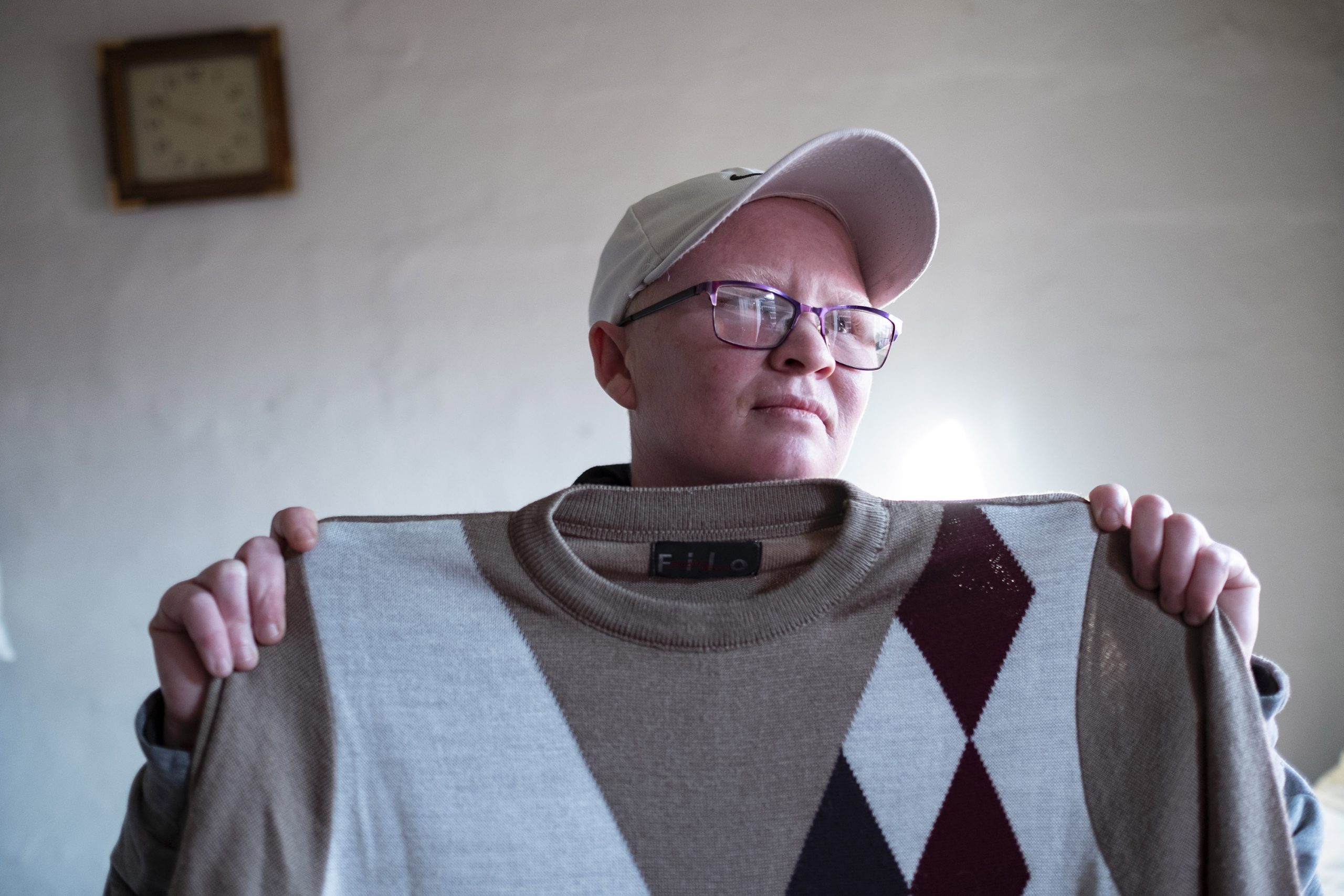 9 June 2020: Valene Meintjies, Cecilia Meintjies’ daughter, lives with her wife in a Wendy house in her mother’s backyard. She holds a jersey that used to belong to Petrus Miggels. (Photographs by Barry Christianson)