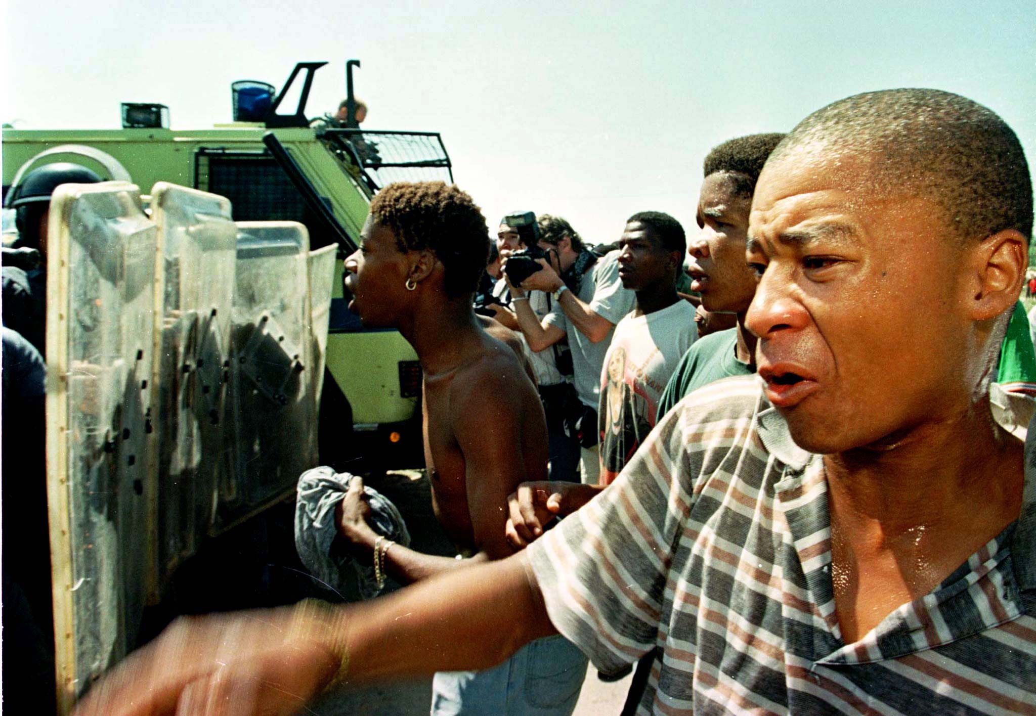 19 March 1998: Black residents of Vryburg clash with the police during the fourth week of racial tension in the town. The police fired rubber bullets and tear gas at the protesters. (Photograph by Juda Ngwenya/ Reuters)